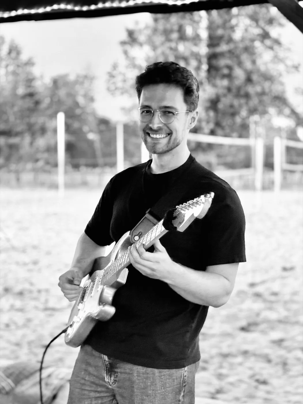 Johannes holding an electric guitar